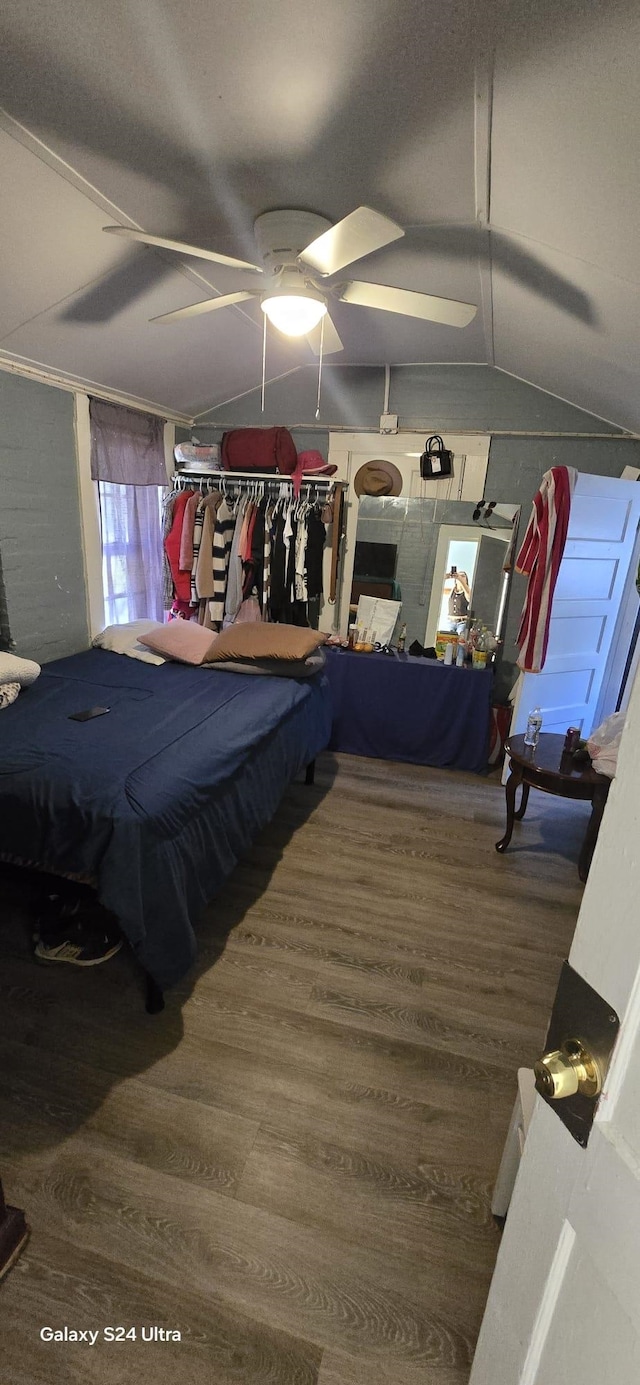 bedroom featuring hardwood / wood-style flooring, vaulted ceiling, and ceiling fan