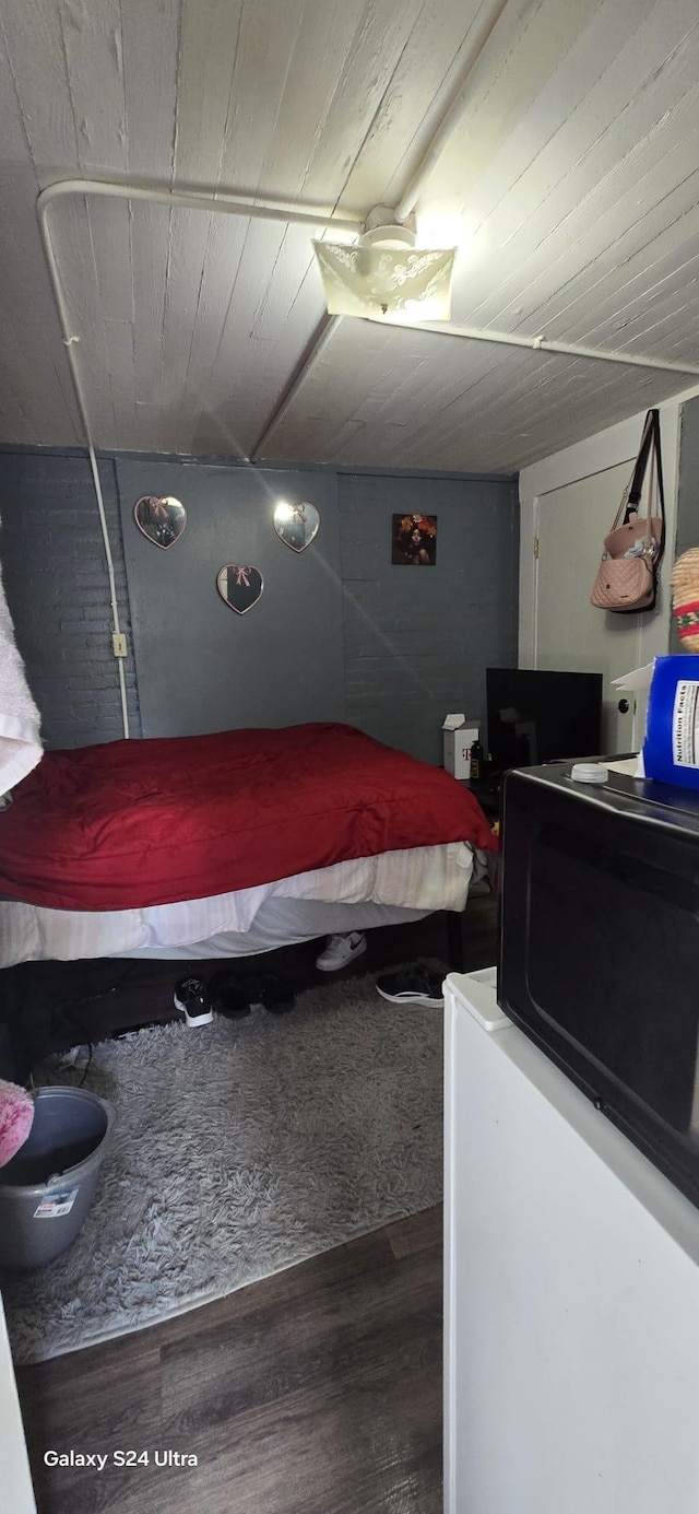 bedroom featuring wood ceiling and wood-type flooring