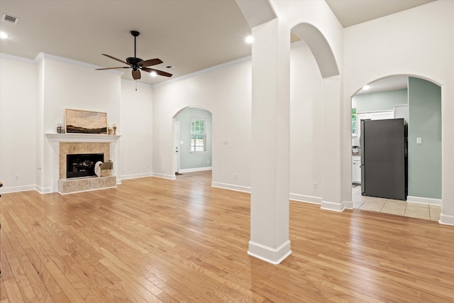 1652 Eagles Watch Way, Tallahassee, FL 32312 - unfurnished living room featuring ceiling fan, light wood-type flooring, ornamental molding, a tile fireplace, and recessed lighting