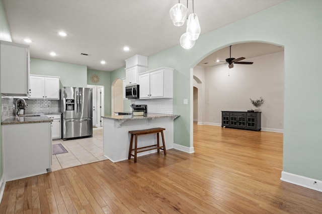 1652 Eagles Watch Way, Tallahassee, FL 32312 - kitchen with stainless steel appliances, arched walkways, tasteful backsplash, and recessed lighting
