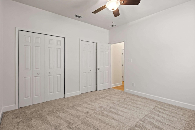 1652 Eagles Watch Way, Tallahassee, FL 32312 - unfurnished bedroom with carpet flooring, two closets, and a ceiling fan