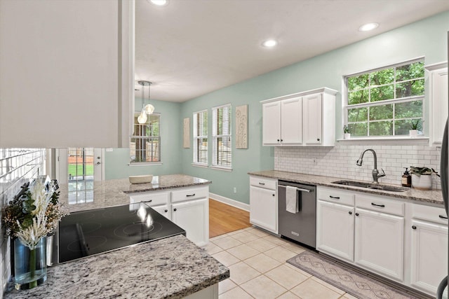 1652 Eagles Watch Way, Tallahassee, FL 32312 - kitchen with dishwasher, stove, white cabinets, light tile patterned floors, and backsplash