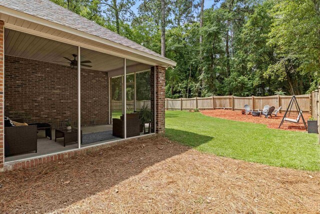 1652 Eagles Watch Way, Tallahassee, FL 32312 - fenced backyard with a patio, a ceiling fan, a fire pit, and view of scattered trees