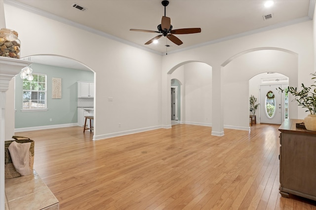 1652 Eagles Watch Way, Tallahassee, FL 32312 - unfurnished living room with a ceiling fan, light wood-style floors, ornamental molding, and arched walkways