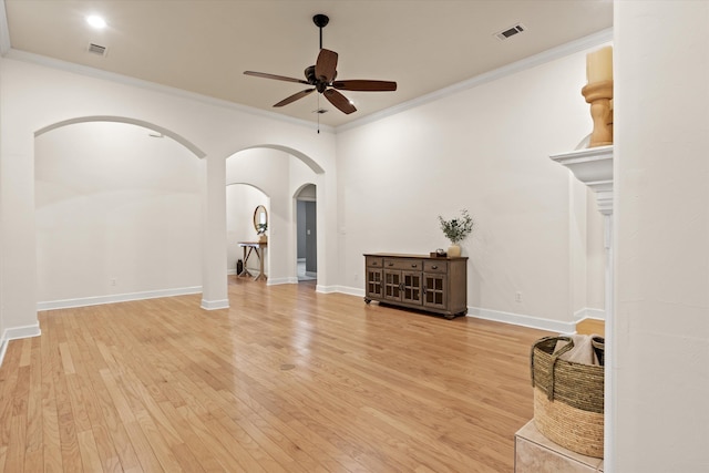 1652 Eagles Watch Way, Tallahassee, FL 32312 - unfurnished living room with a ceiling fan, light wood-type flooring, arched walkways, and ornamental molding