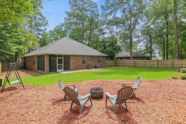 1652 Eagles Watch Way, Tallahassee, FL 32312 - rear view of property with a fire pit, a sunroom, brick siding, and a fenced backyard