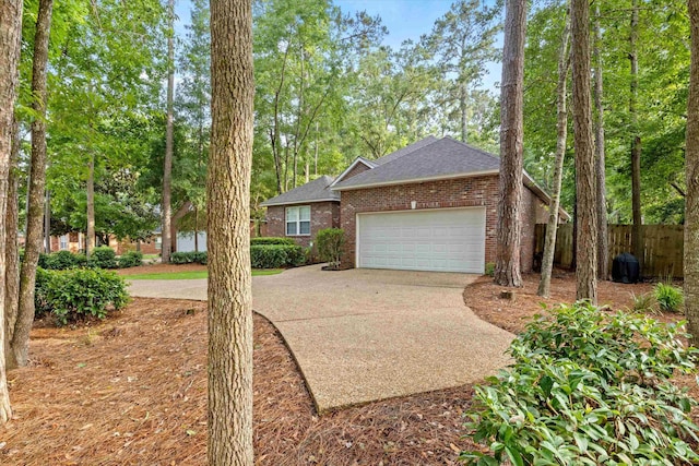 1652 Eagles Watch Way, Tallahassee, FL 32312 - view of property exterior featuring brick siding, a garage, a shingled roof, and concrete driveway