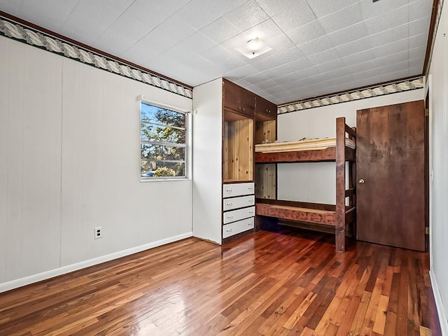 unfurnished bedroom featuring dark hardwood / wood-style flooring