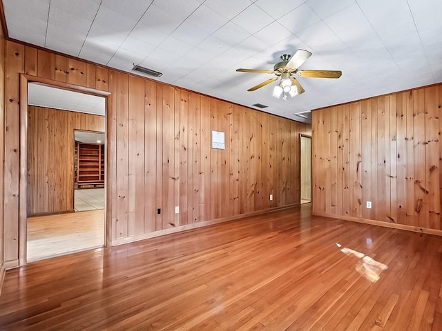 empty room featuring wood-type flooring and ceiling fan