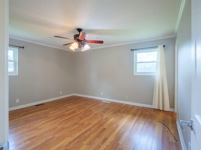 405 NW Whispering Pines Loop, Madison, FL 32340 - unfurnished room with crown molding, plenty of natural light, ceiling fan, light wood-style floors, and a textured ceiling