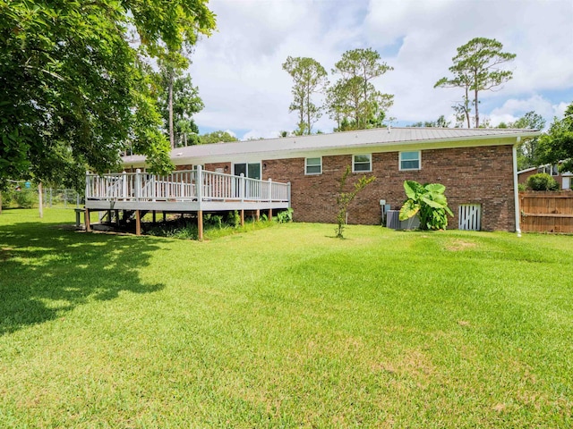 405 NW Whispering Pines Loop, Madison, FL 32340 - back of property with brick siding, a wooden deck, and a metal roof