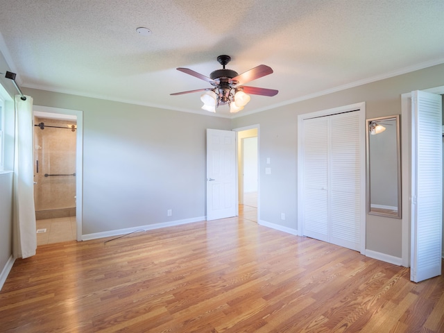405 NW Whispering Pines Loop, Madison, FL 32340 - unfurnished bedroom featuring light wood finished floors, ornamental molding, a textured ceiling, a ceiling fan, and ensuite bathroom