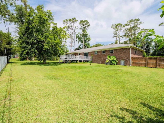 405 NW Whispering Pines Loop, Madison, FL 32340 - fenced backyard with a wooden deck