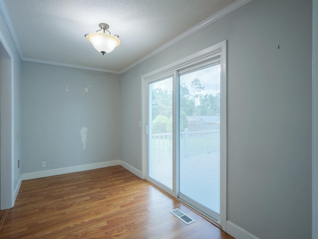405 NW Whispering Pines Loop, Madison, FL 32340 - unfurnished room featuring light wood-style floors, ornamental molding, and a textured ceiling
