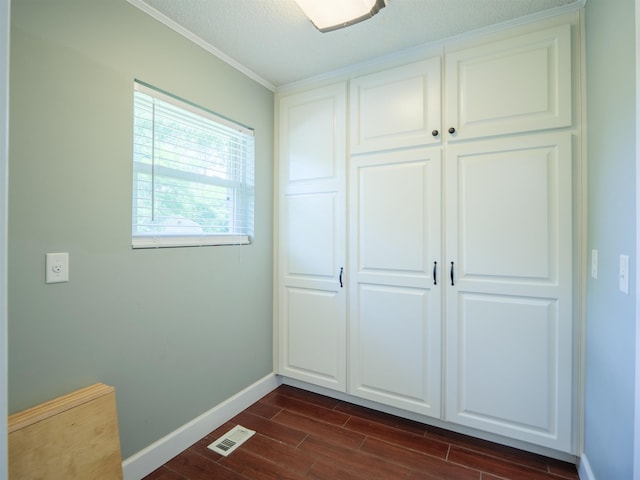 405 NW Whispering Pines Loop, Madison, FL 32340 - unfurnished bedroom featuring dark wood-style flooring, ornamental molding, and a closet