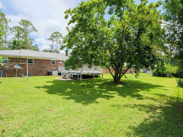 405 NW Whispering Pines Loop, Madison, FL 32340 - view of green lawn featuring a deck