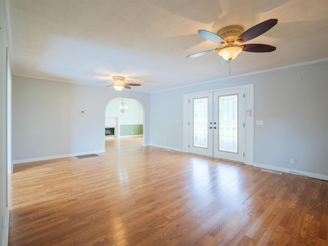 405 NW Whispering Pines Loop, Madison, FL 32340 - unfurnished room with ceiling fan, ornamental molding, arched walkways, french doors, and light wood-type flooring