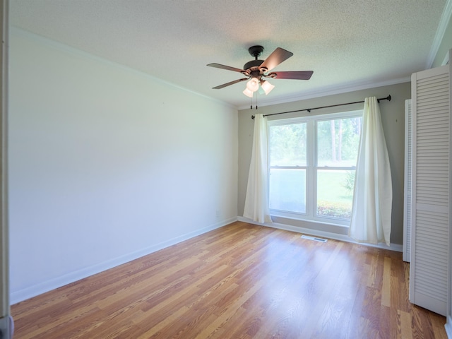 405 NW Whispering Pines Loop, Madison, FL 32340 - empty room with ornamental molding, light wood-style flooring, ceiling fan, and a textured ceiling