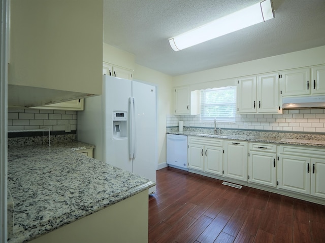 405 NW Whispering Pines Loop, Madison, FL 32340 - kitchen with white appliances, decorative backsplash, and light stone countertops