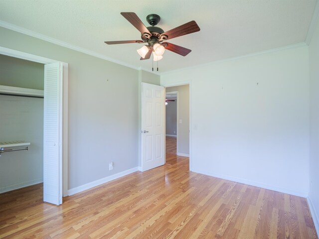 405 NW Whispering Pines Loop, Madison, FL 32340 - unfurnished bedroom with light wood-style floors, ornamental molding, a closet, and a ceiling fan