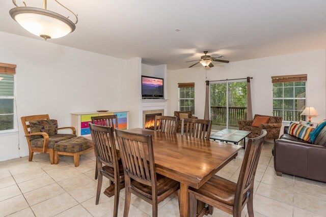 tiled dining area with ceiling fan