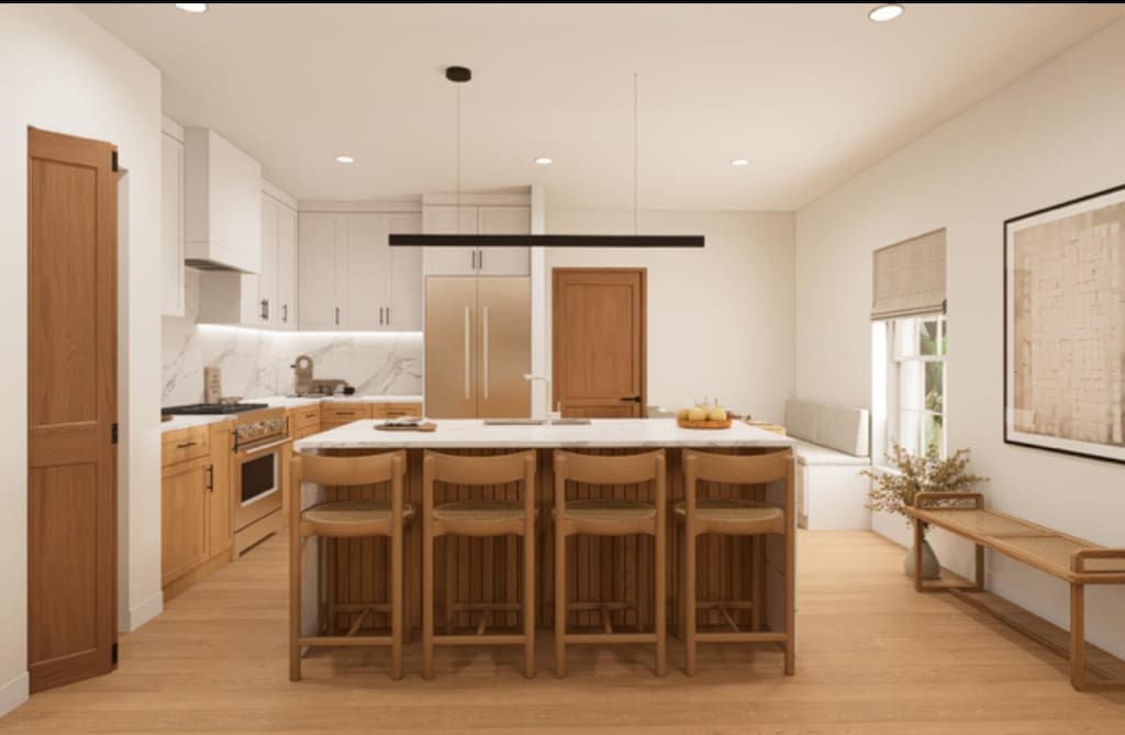 4633 Shelfer Rd, Tallahassee, FL 32305 - kitchen featuring high end appliances, light countertops, light wood-style flooring, backsplash, and a center island with sink
