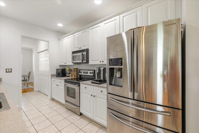 kitchen featuring light tile patterned floors, white cabinets, recessed lighting, light countertops, and stainless steel appliances