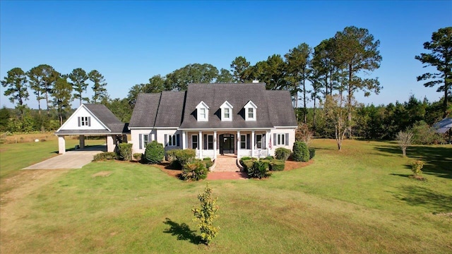 cape cod-style house with a front lawn, a porch, and a carport