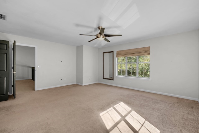 unfurnished room featuring light carpet and ceiling fan