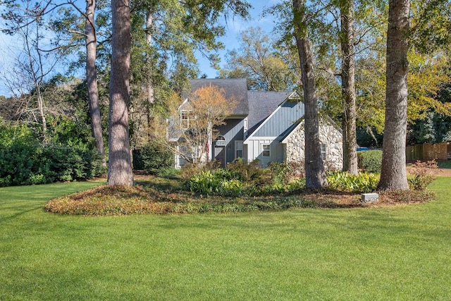 view of side of property featuring a yard and board and batten siding