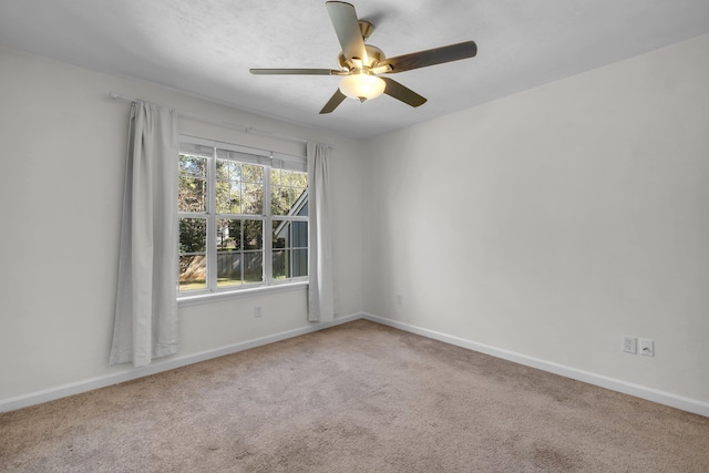 empty room with carpet floors and ceiling fan