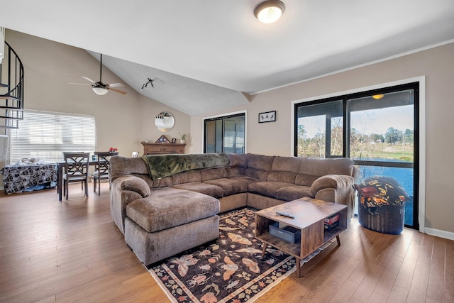 living room featuring vaulted ceiling and wood-type flooring