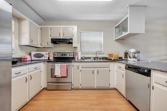 kitchen with light hardwood / wood-style floors, sink, extractor fan, appliances with stainless steel finishes, and white cabinets