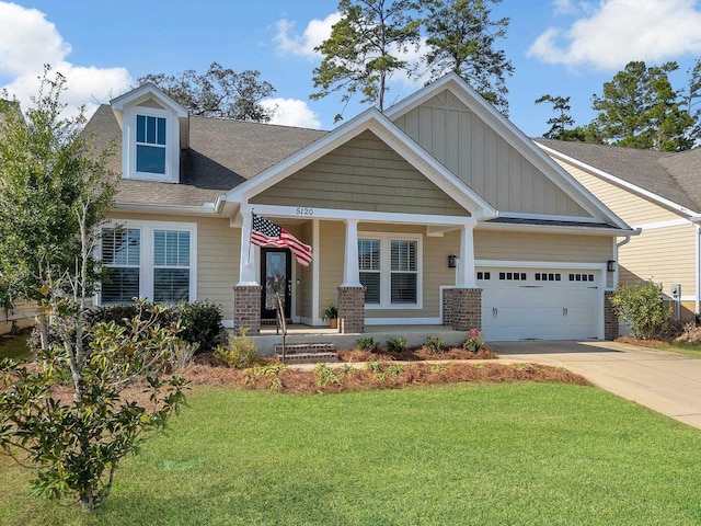 craftsman house featuring a porch, a garage, and a front lawn