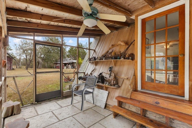 sunroom / solarium featuring wood ceiling, beam ceiling, and ceiling fan