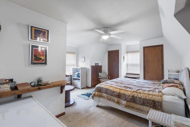 carpeted bedroom featuring multiple windows and ceiling fan