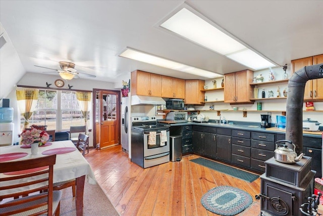 kitchen featuring appliances with stainless steel finishes, light brown cabinetry, sink, ceiling fan, and light wood-type flooring