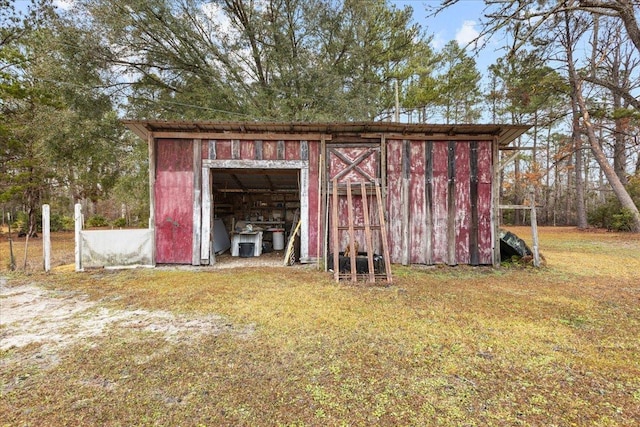 view of outdoor structure featuring a lawn