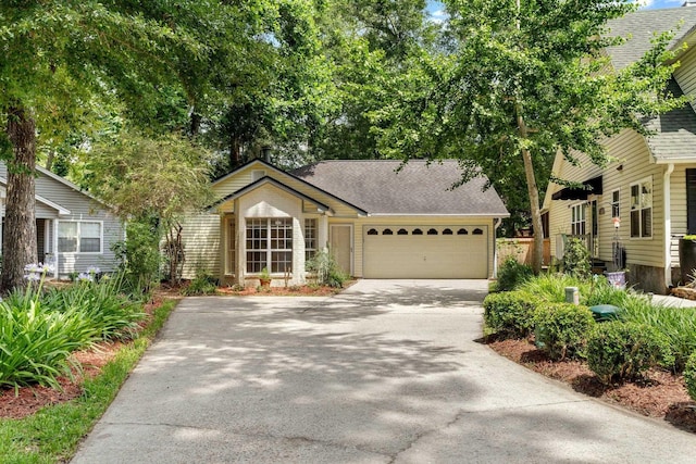 2632 Nantucket Ln, Tallahassee, FL 32312 - view of front facade with concrete driveway, a garage, and a shingled roof