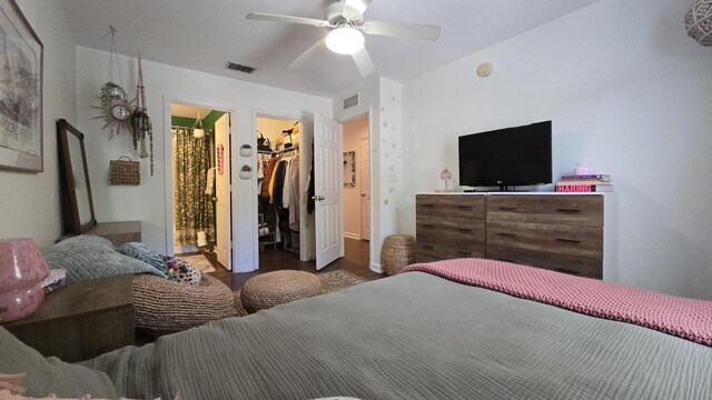 2301 Timber Oaks Ln Bldg 2, Tallahassee, FL 32304 - bedroom featuring a walk in closet, wood finished floors, a closet, and a ceiling fan