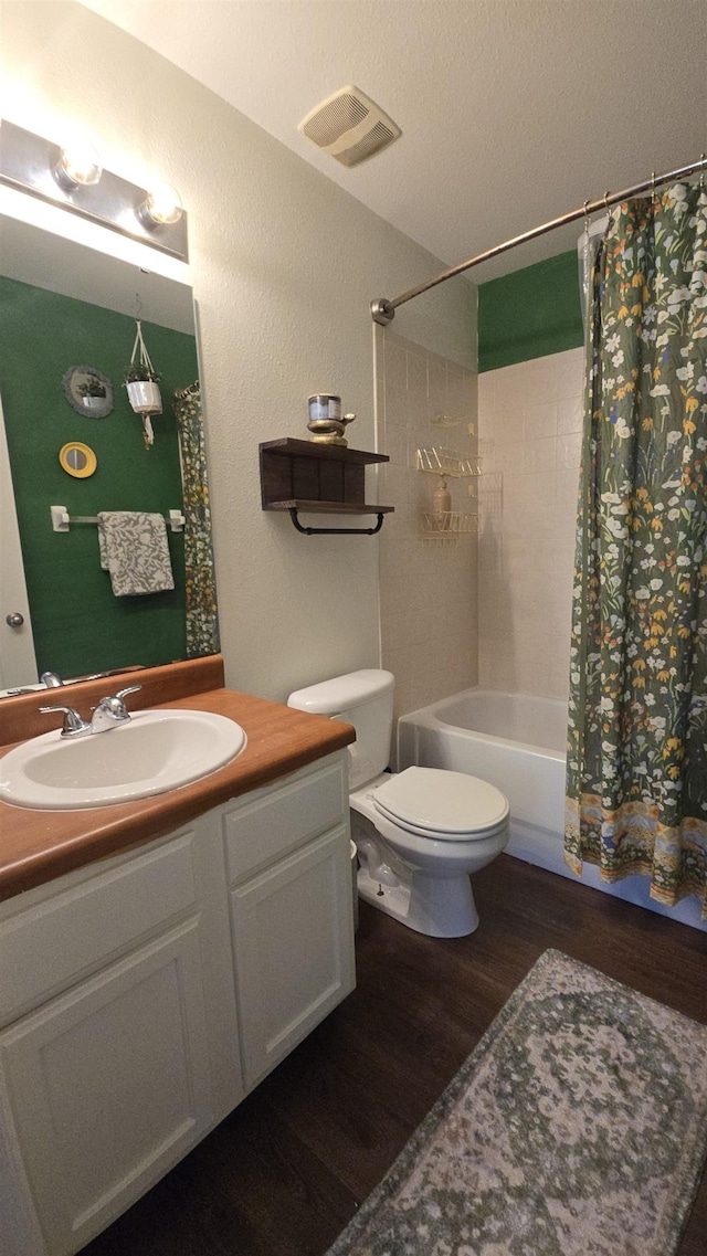 2301 Timber Oaks Ln Bldg 2, Tallahassee, FL 32304 - full bath with wood finished floors, vanity, toilet, and shower / tub combo with curtain