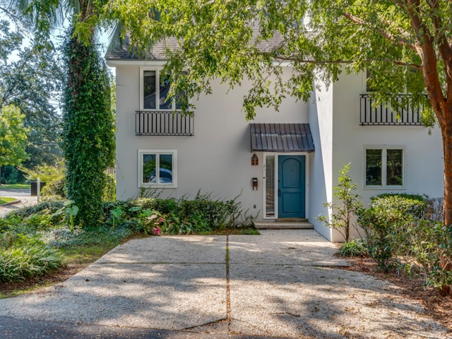 view of front of home with a balcony