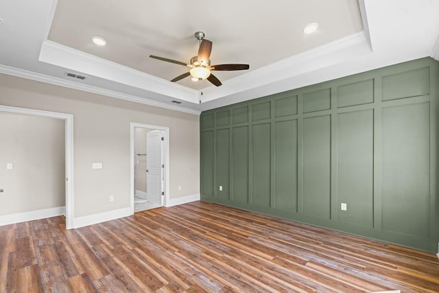 unfurnished bedroom with ceiling fan, crown molding, and a tray ceiling