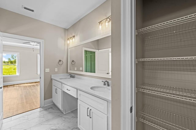 bathroom featuring ceiling fan and vanity