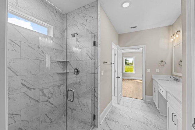 bathroom with vanity and a shower with shower door