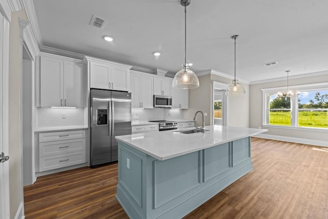 kitchen featuring stainless steel appliances, sink, a center island with sink, a chandelier, and hanging light fixtures