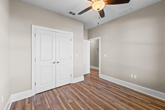 unfurnished bedroom featuring ceiling fan, a closet, and hardwood / wood-style floors