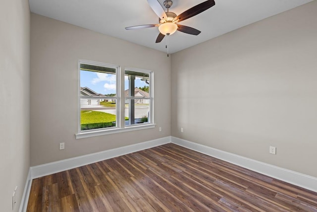 unfurnished room with dark hardwood / wood-style floors and ceiling fan