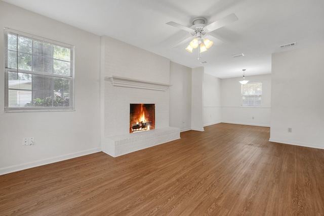 5804 Old Forge Ct, Tallahassee, FL 32317 - unfurnished living room with wood finished floors, ceiling fan, and a fireplace