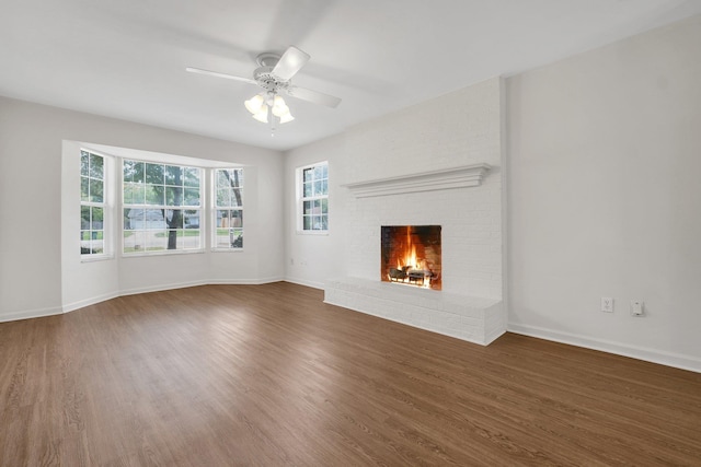 5804 Old Forge Ct, Tallahassee, FL 32317 - unfurnished living room with wood finished floors, a ceiling fan, and a fireplace